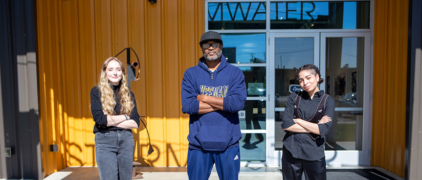 Ken Tips, Madeline Walshe, and Anthony Lewis stand outside of Stormwater Studios.