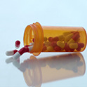 Photo of pill bottle emptying out.