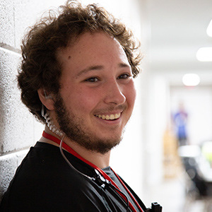 photo of a man smiling with an earpeice on during filming 