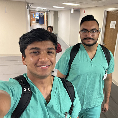 two men smiling in aqua scrubs