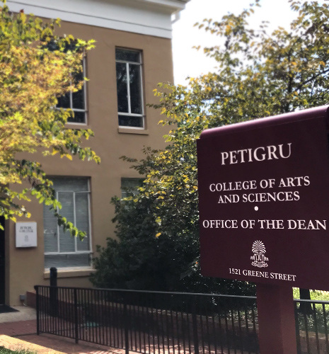 Sign for pettigru stands before the building housing the Dean's Office