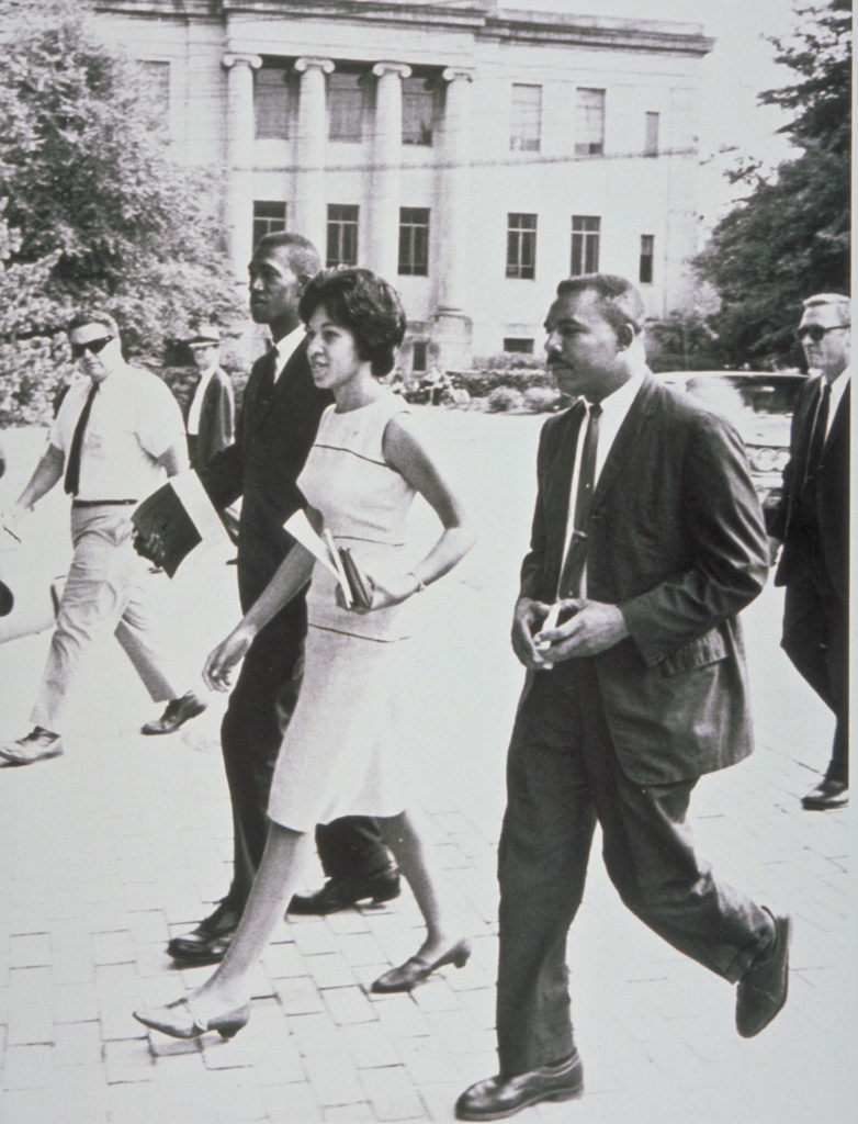 A black and white photo of Mr Solomon, Ms. Henrie Monteith Treadwell, and Mr. Robert Anderson walking