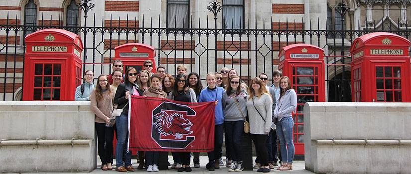 Students holding a USC flag in London