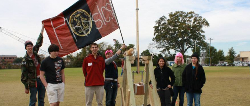 Students of the SPS raising a Physics flag.