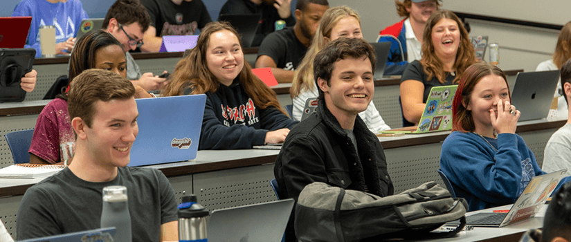 students in class smiling and laughing 