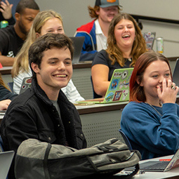 undergrad male student smiling in class