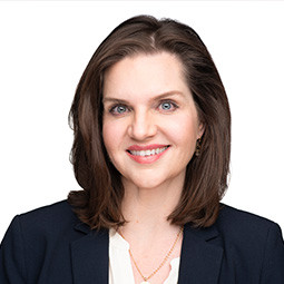 woman with black jacket on and dark hair 