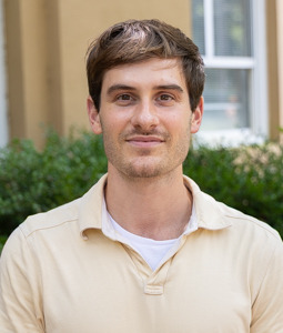 a man in a gray suit and dark hair