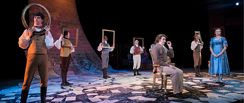 Actors on a stage, each holding a large picture frame in front of their faces.
