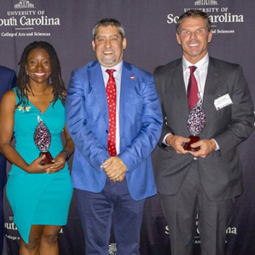College of Arts and Sciences' Dean Samuels poses for a photo with alumni at the Recognition of Excellence Awards.