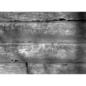 A black and white photograph by Joshua Kendrick depicting weathered wood.