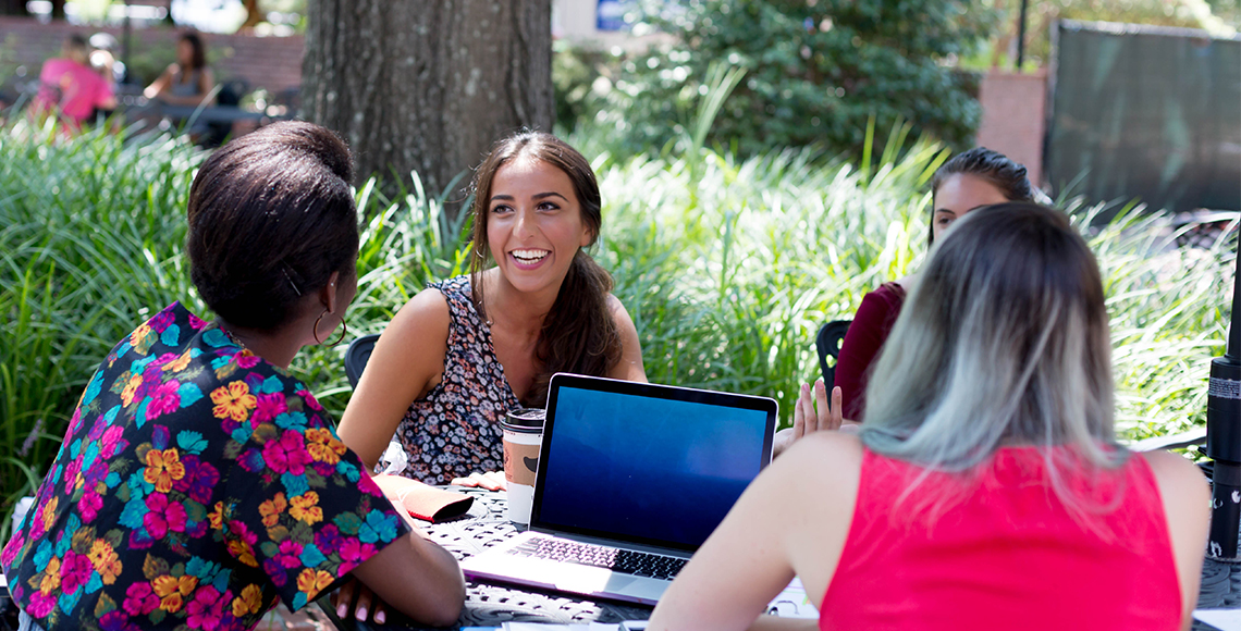 students studying at the russell house patio