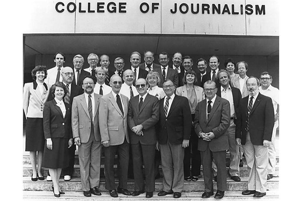 Faculty in 1985 - Gathered in front of the College of Journalism are (front row, l to r), Nancy Clark, Jerry Jewler, Bill Goodrich, Dean Joe Shoquist, John Lopiccolo, Lee Dudek, Jay Latham; (second row, l to r) Pat McNeely, Rick Uray, Bruce Konkle, Jon Wardrip, Florence Feasley, Beth Dickey, Bill Rogers, Don Woolley; (third row, l to r) Kent Sidel, Don McKinney, Henry Schulte, Erik Collins, Perry Ashley, Henry Price, Bill Brown, Ralph Morgan, Bob Jones, Ron Farrar, Charlie Sanders, Rick Stephens, Mary Caldwell and Jack Hillwig.