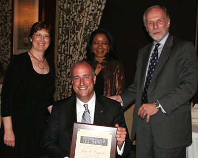 Jack Claypoole presented with alumni award by Charles Bierbauer, Shirley Staples Carter and Lynn Zoch.