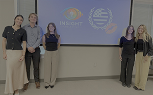 students standing in front of a blue screen