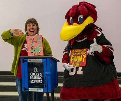 Margaret Cook Jackson and Cocky, both holding books