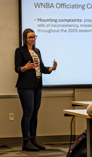 Kelly Evans in front of whiteboard