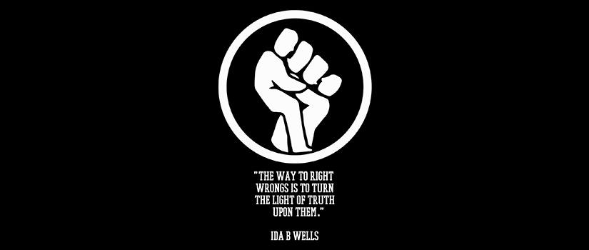 In the shape of a lightbulb, a drawing of a fist and underneath it a quote from Ida B. Wells: The way to right wrongs is to turn the light of truth upon them.
