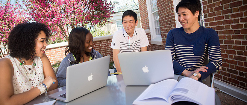 Students sitting on the rooftop garden with computers