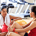 Two women talking in a gym