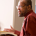 african-american man holding book and speaking