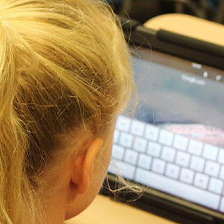 blonde girl working on tablet