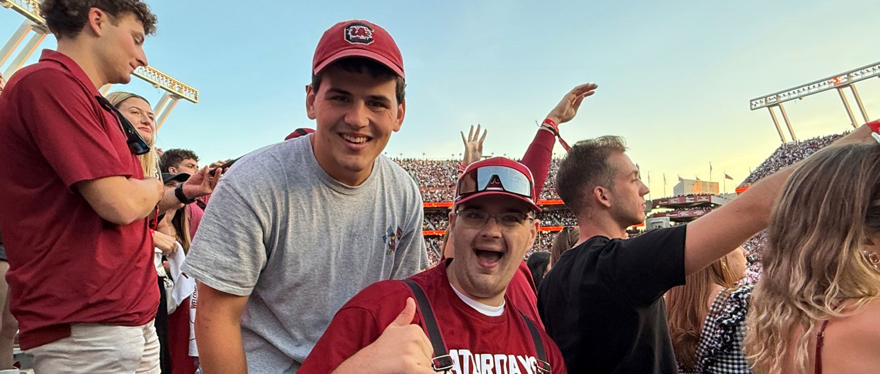 CarolinaLIFE students at a football game giving "Spurs Up!" gesture