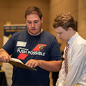 recruiter talks to student at a career fair