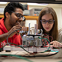 two students work together in a lab