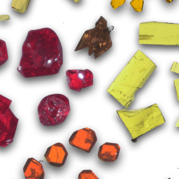 close-up view of multi-colored crystals on a white background