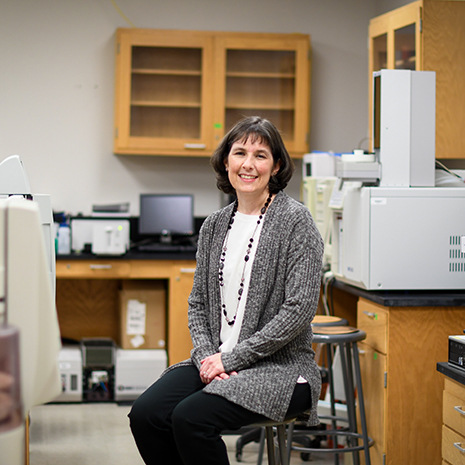 Dr. Berge sits in her lab