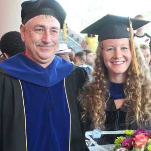 Kate Mingle stnds with Dr. Lauterbach at graduation