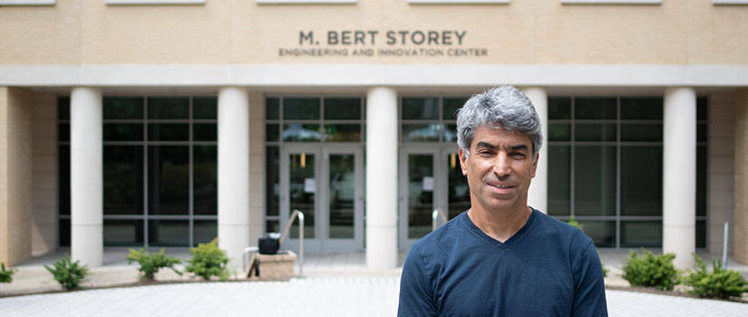 Professor Homayoun Valafar standing in front of the Storey Innovation Center.
