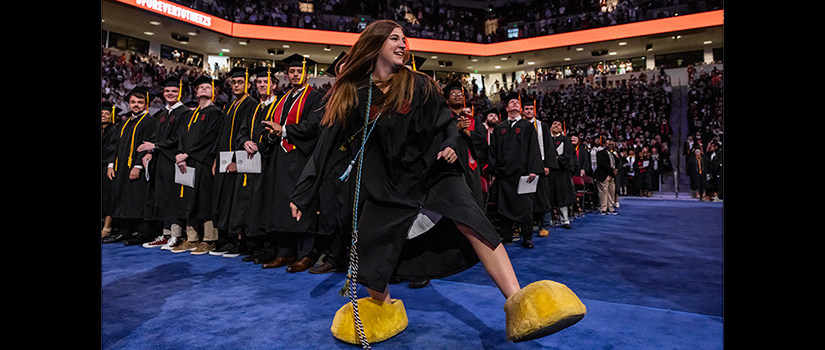CEC student Sarah Sylvester's last official acts as Cocky, donning the iconic yellow mascot shoes and walking across the graduation stage at Colonial Life Arena