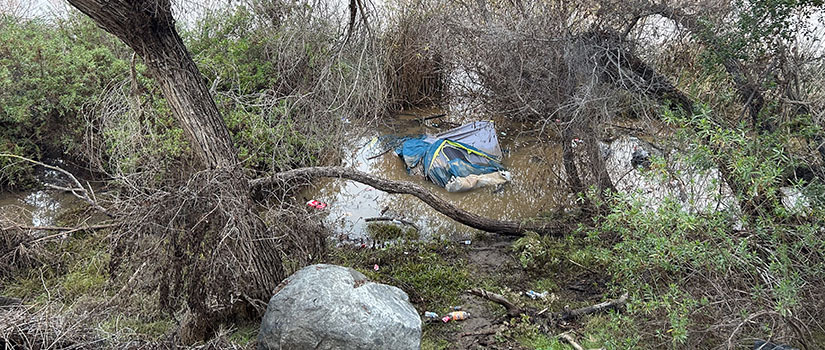 A tent floats in the San Diego River after heavy rains caused flooding. 