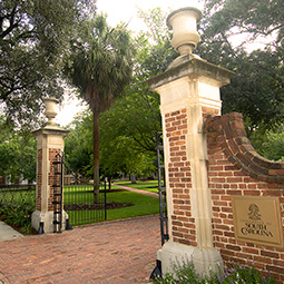 Two brick columns with a UofSC plaque on one side at the open entrance to the Horseshoe area of campus.