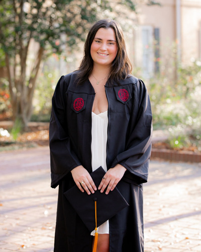 Ruth Moniz posing in graduation robes