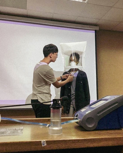 Man adjusting mask on woman's face