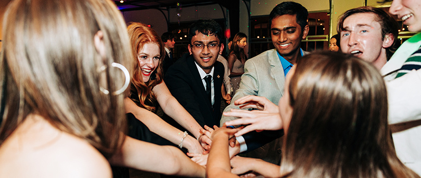 Group of Top Scholars cheering at their spring formal dance.