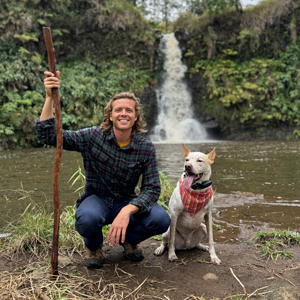 Kurtyss Kasten posing with dog on a nature walk.
