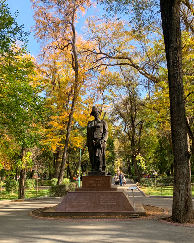 Bronze statue in front of forest