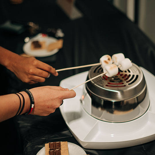 students roasting marshmallows