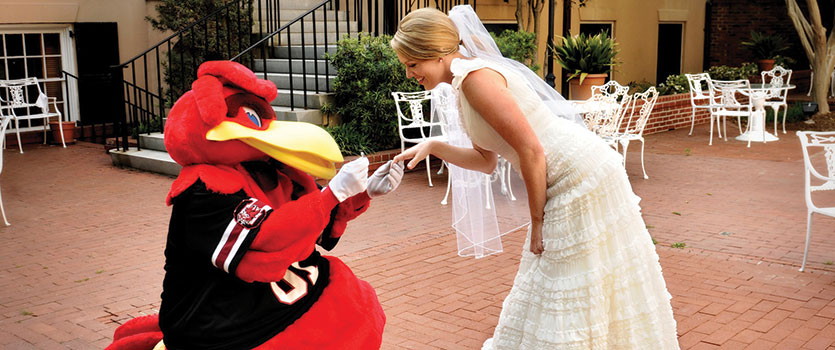 Cocky proposes to a blushing bride on the patio of the historic McCutchen House.