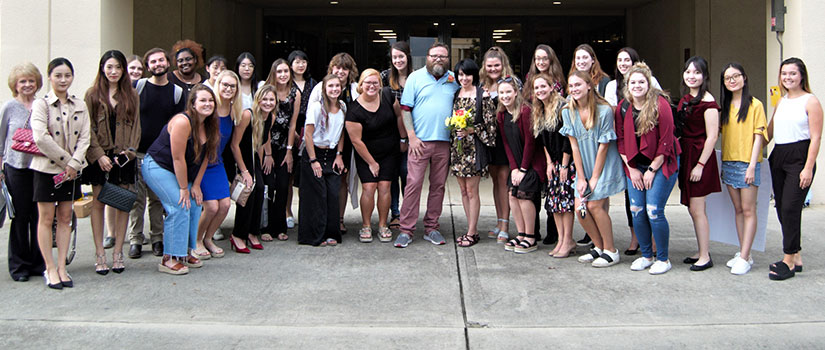 Engaged couple Jillian Owen and Brad Morris pose with students from Instructor Annette Hoover's wedding planning class, HRTM 362. Each fall, students in the class choose a lucky couple to receive a free wedding.