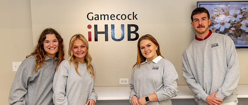 A group of four students posed in the Gamecock iHub store.