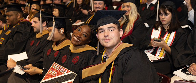 Two HRSM graduates pose