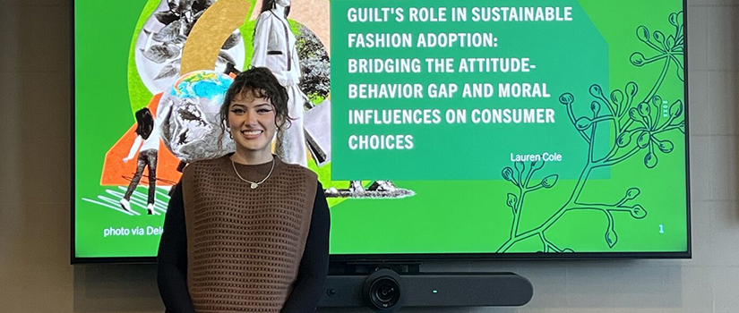 Graduate student presents thesis on sustainable fashion adoption and Gen Z consumer behavior in classroom setting