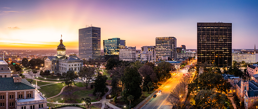 Columbia, South Carolina, USA downtown city skyline from above roadways at dawn.