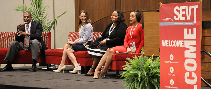Panelists share a laugh on stage during a discussion at the 2021 SEVT Conference