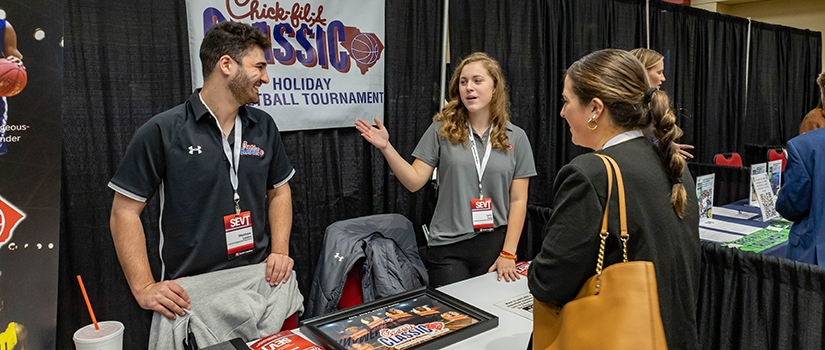 Representatives from the Chick-fil-A Classic speak with students at the career fair at the Sport Entertainment and Venues Tomorrow conference.